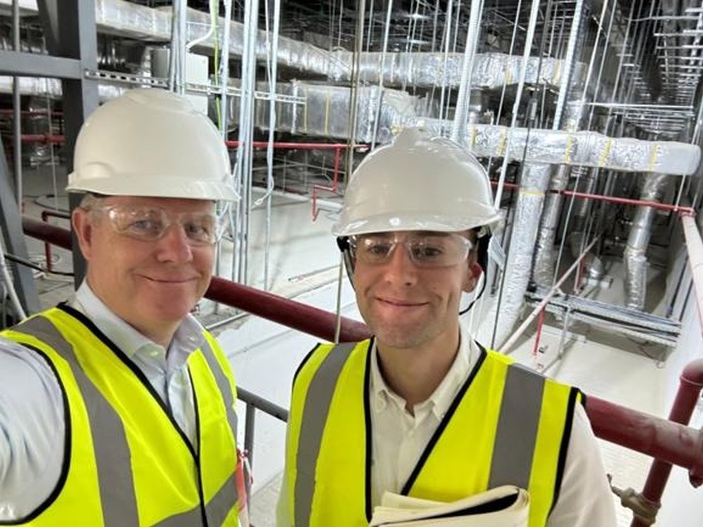 Two Ramskov colleagues in hard hats and hi-vis on a factory visit
