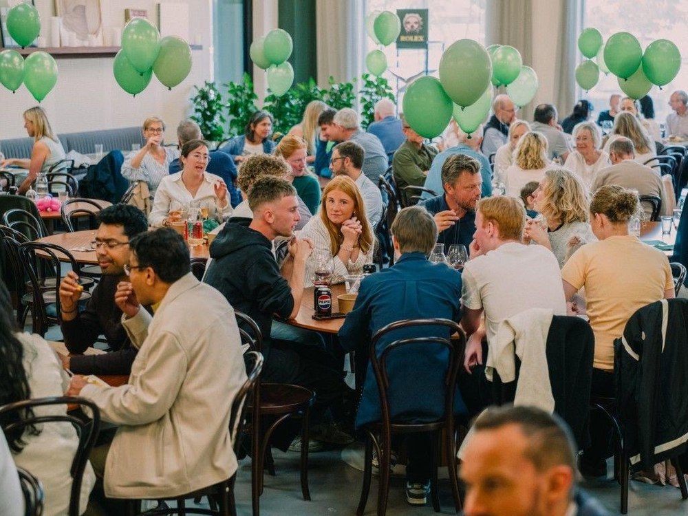 Ramskov family and friends gathered around tables with green balloons