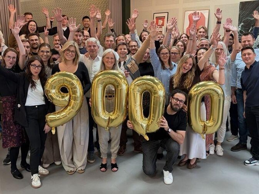 The Ramskov team celebrating 9,000 LinkedIn followers with gold number balloons