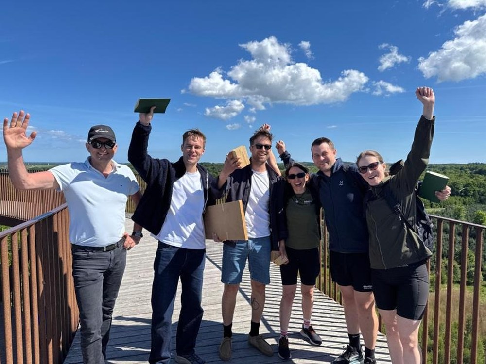 The Ramskov team celebrating with arms raised at their 2026 summit